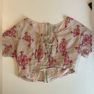 Crop with zip in back and lace up front that’s tie able and adjustable